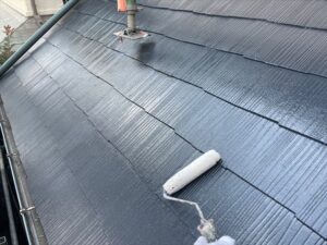 上尾市にて下屋根のトップコート塗布作業中の写真